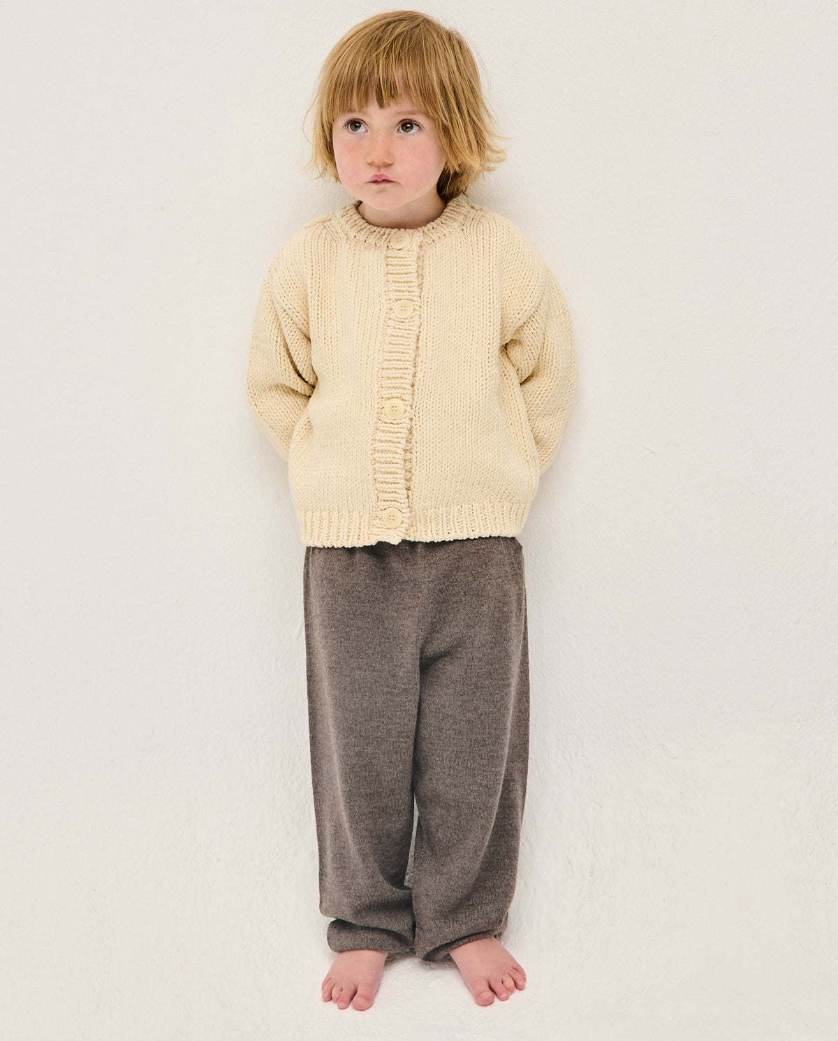 Kids' natural beige cardigan by Babaà, soft knit fabric, front buttons, and cozy fit, perfect for children.