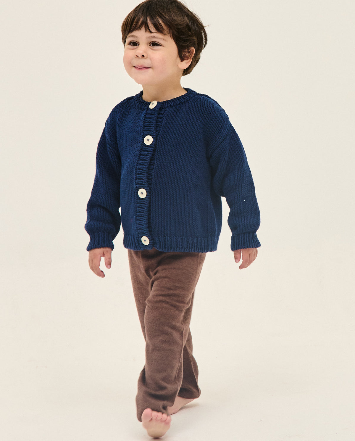Navy baby cardigan from Babaà for kids, featuring soft knit fabric and button closure, perfect for casual or dressy wear.