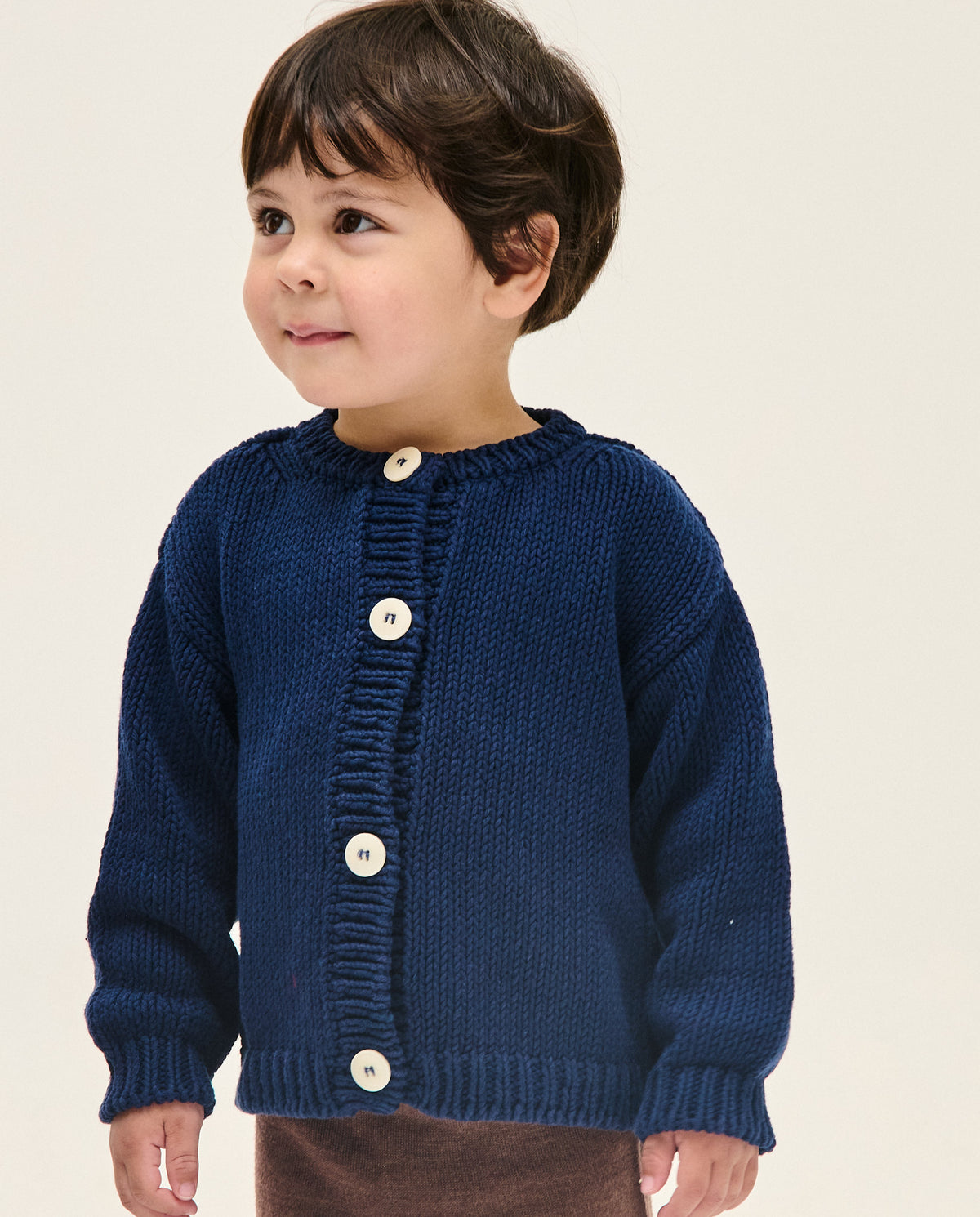 Navy children's cardigan from Babaà, No14 style, featuring a cozy knit with button closure and ribbed cuffs.
