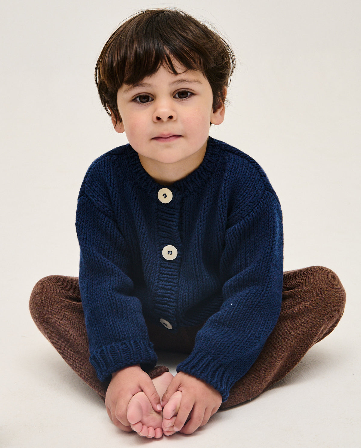Navy kids' cardigan from Babaà with button closure, soft knit fabric, and ribbed cuffs, perfect for casual wear.