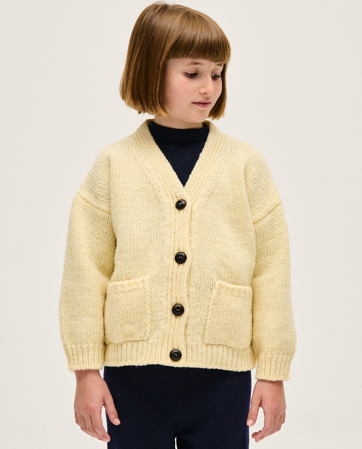 Baby girl's natural Babaà No17 cardigan with soft knit fabric, button closure, and cozy design for stylish comfort.