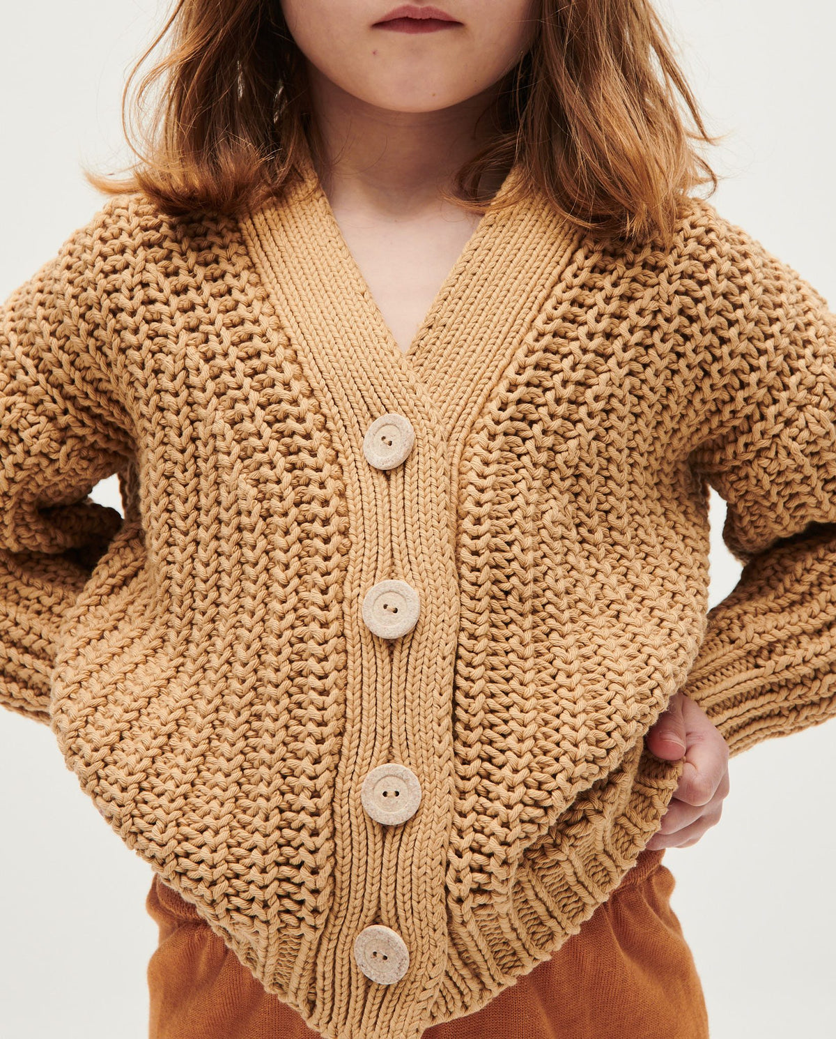 Kids' cardigan by Babaà in Chicory Root color, soft knit with a cozy, stylish design perfect for children's casual wear.