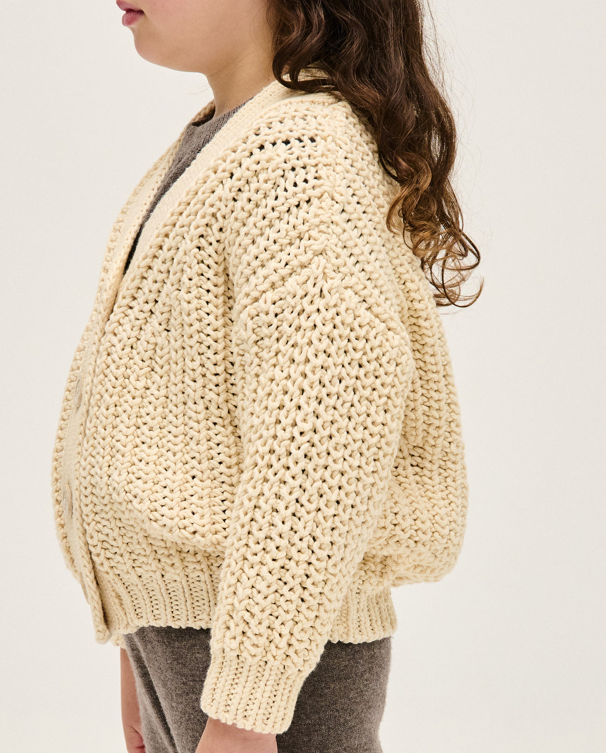 Kids' natural-colored Babaà No18 cardigan with long sleeves and button closure, soft knit fabric, and ribbed cuffs.