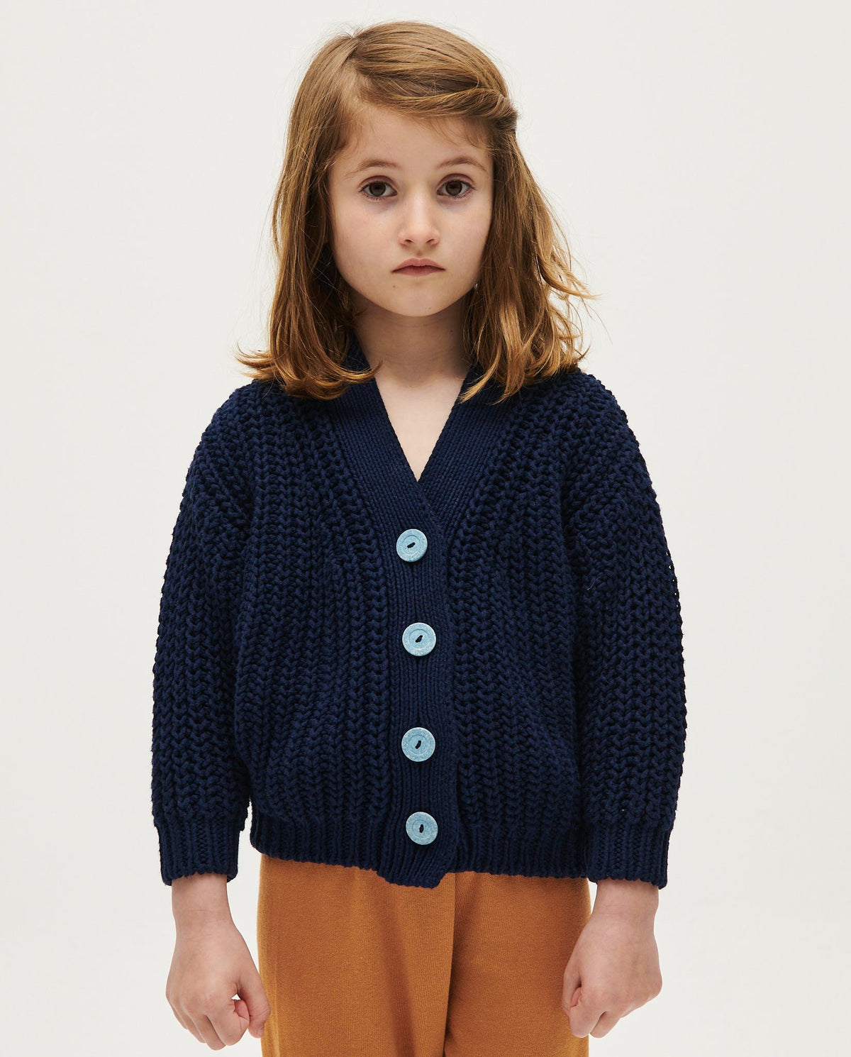 Navy kids' cardigan by Babaà with button closure, soft knit fabric, and ribbed cuffs, designed for comfort and style.