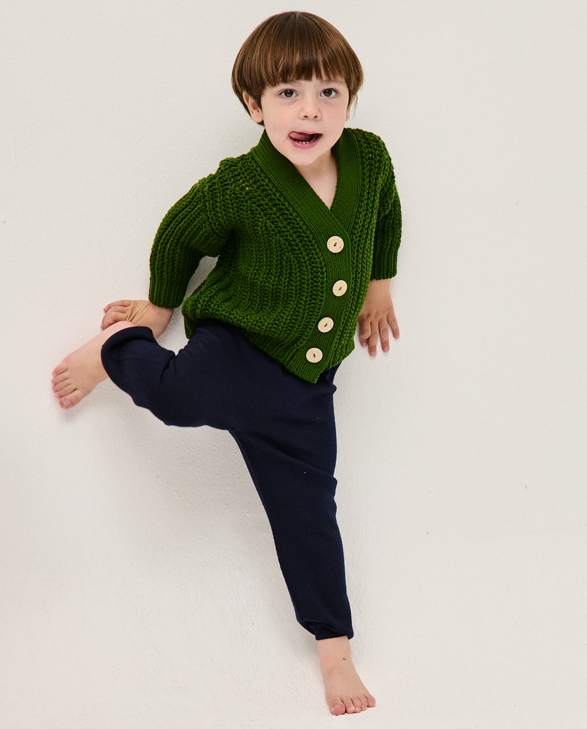 Kids' Babaà No18 pine cardigan with a cozy knit design, featuring a soft, natural pine green color and button closure.