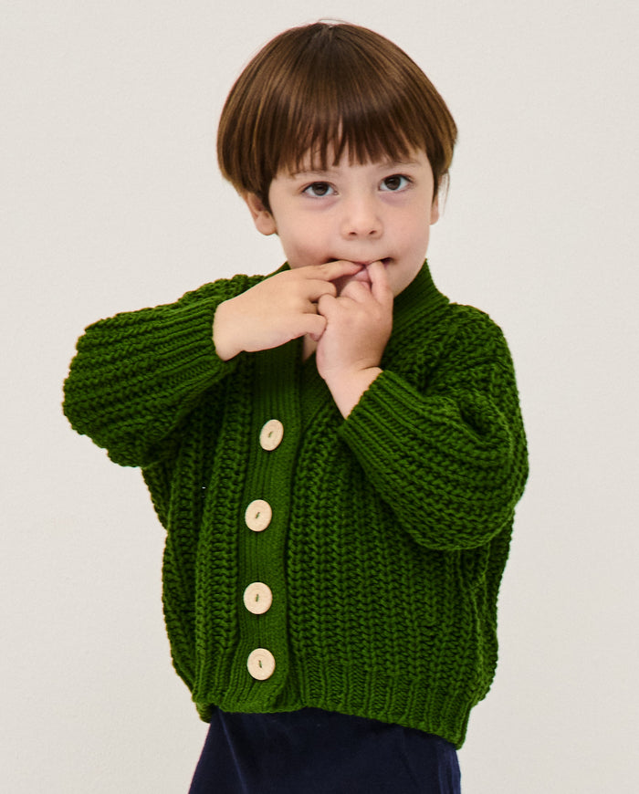 Kids' Babaà No18 pine cardigan featuring a cozy knit with a button-up front and ribbed cuffs, perfect for fall and winter wear.