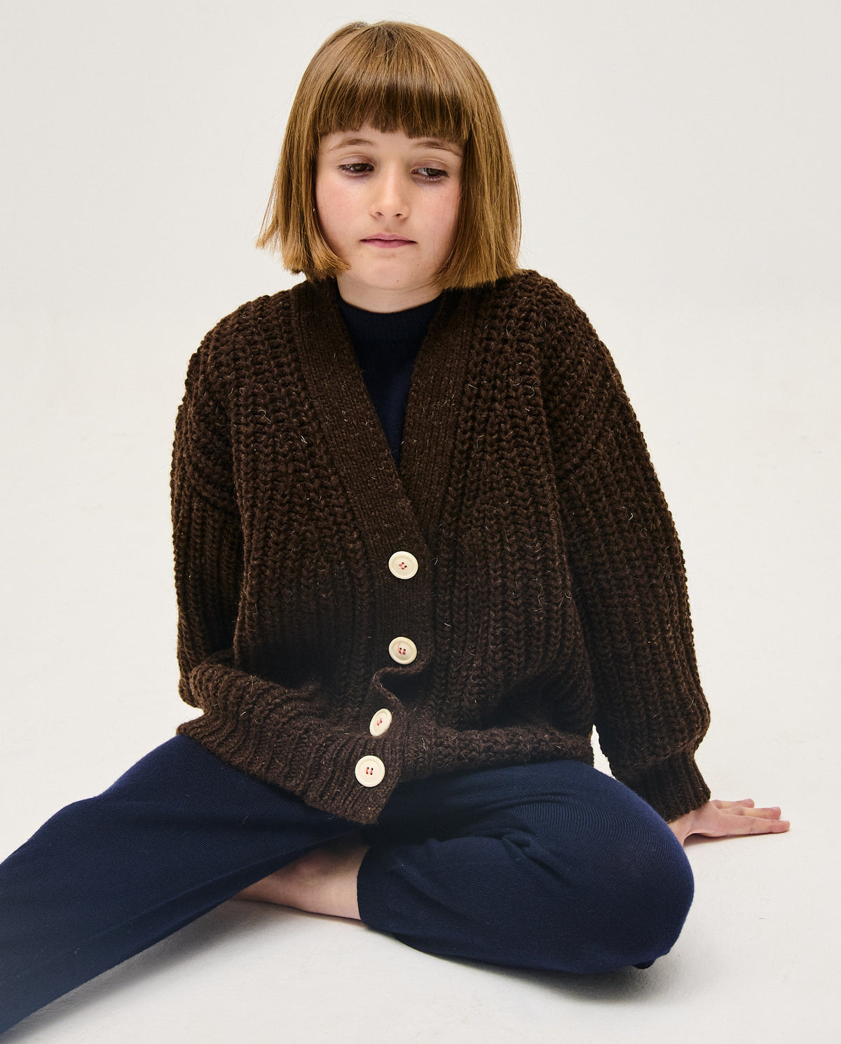 Kids' Babaà No19 Earth cardigan, soft knit with earthy tones, featuring button closure and ribbed cuffs, perfect for cozy play.