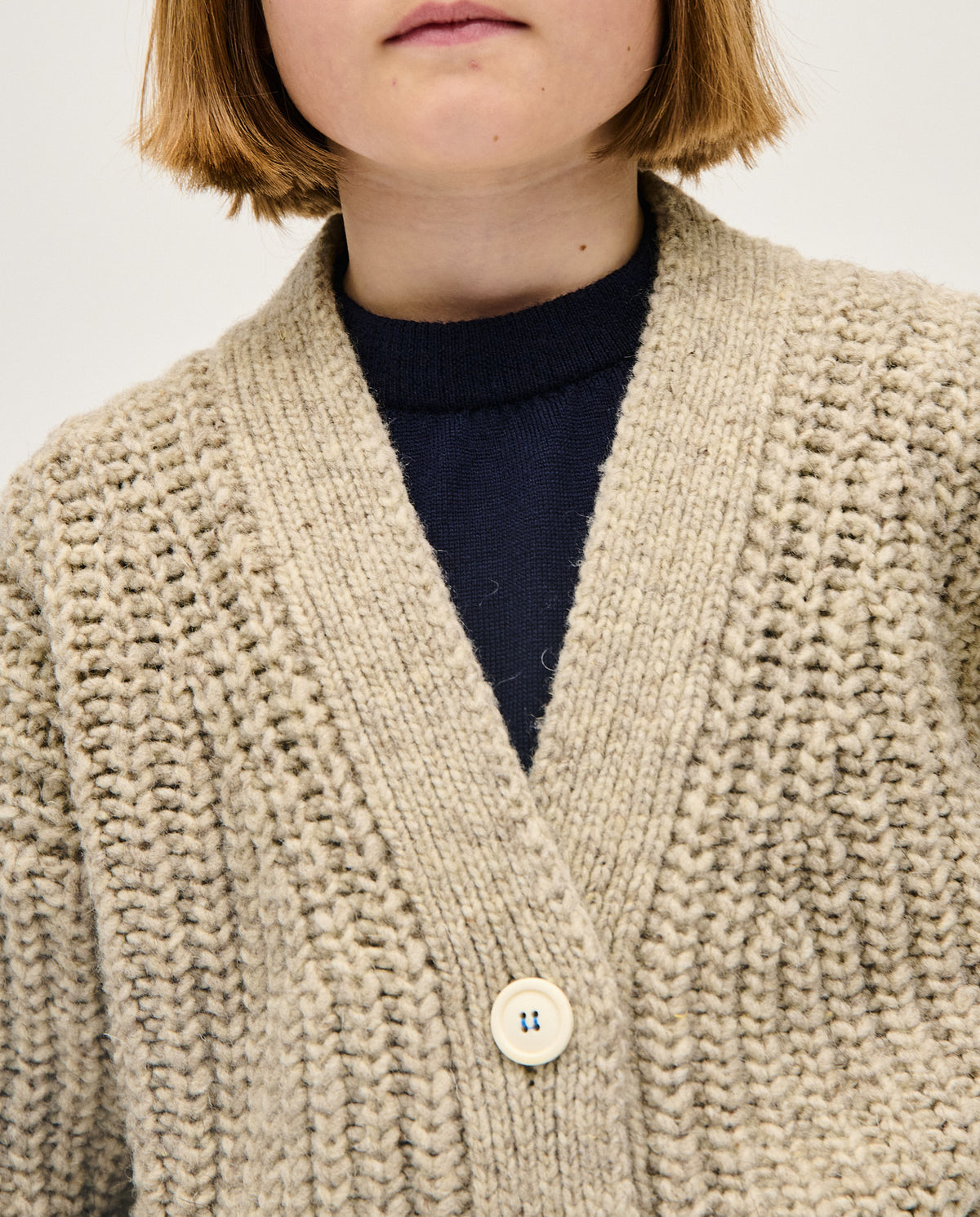 Kids' Babaà No19 Mist cardigan in soft knit, featuring a cozy design with buttons and ribbed cuffs for comfortable wear.