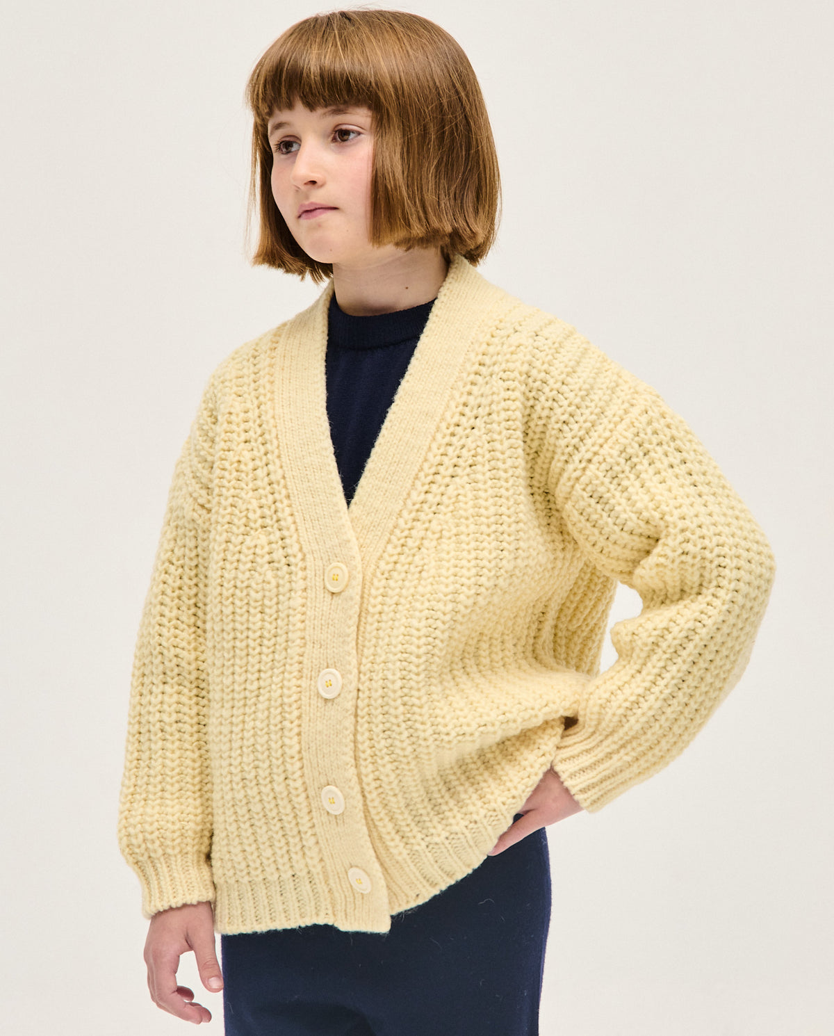 Babaà kids no19 natural cardigan, soft knitted children's sweater with button closure and cozy fit, in a natural beige color.