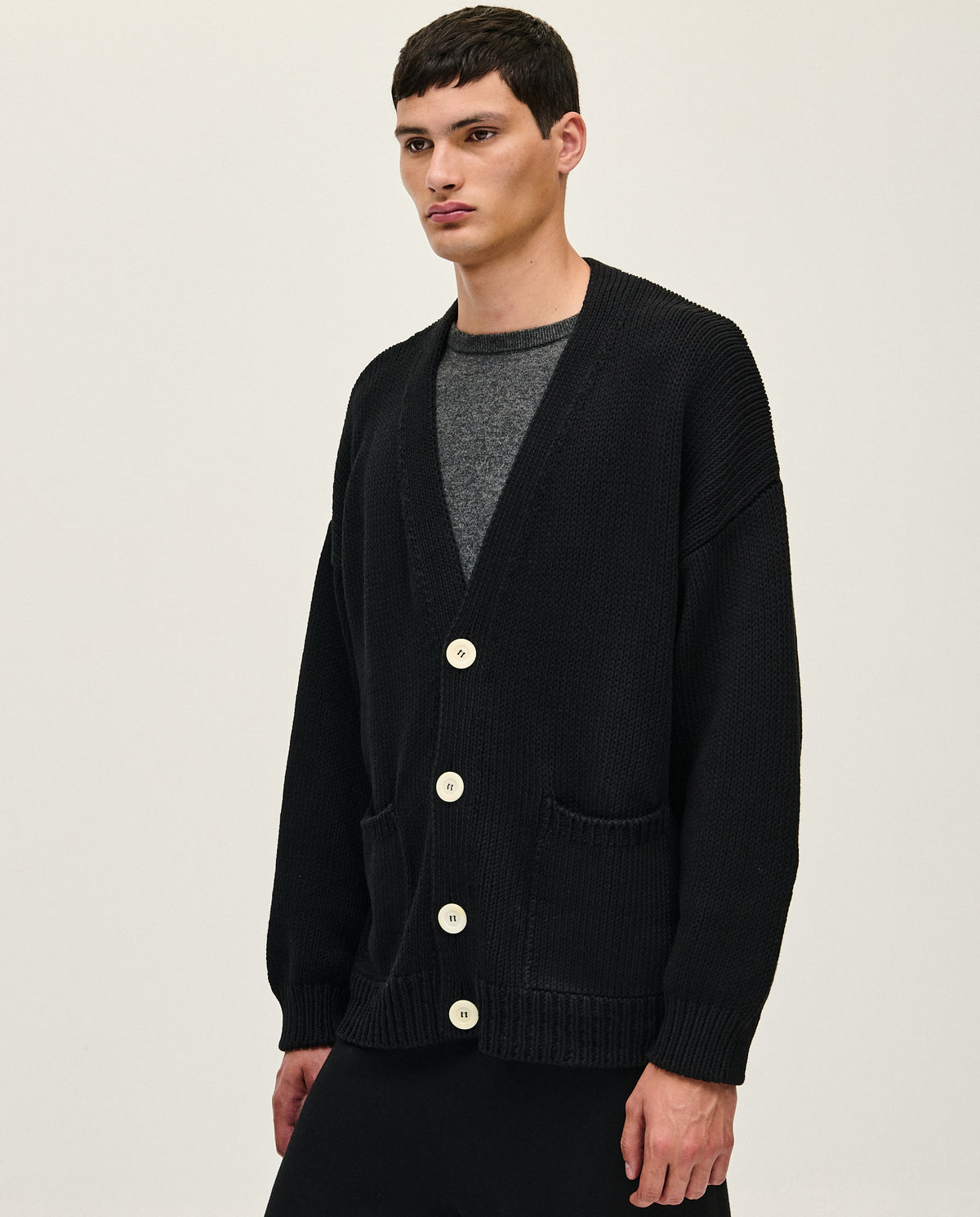 Black men's cardigan No16 by Babaà, shown on a model with a button-up front and ribbed cuffs, casual and stylish.