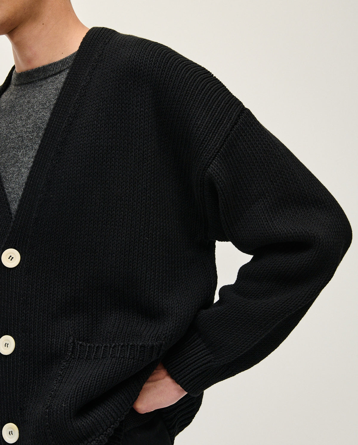 Black men's cardigan from Babaà No16, featuring a cozy knit design with a button-up front and ribbed cuffs.