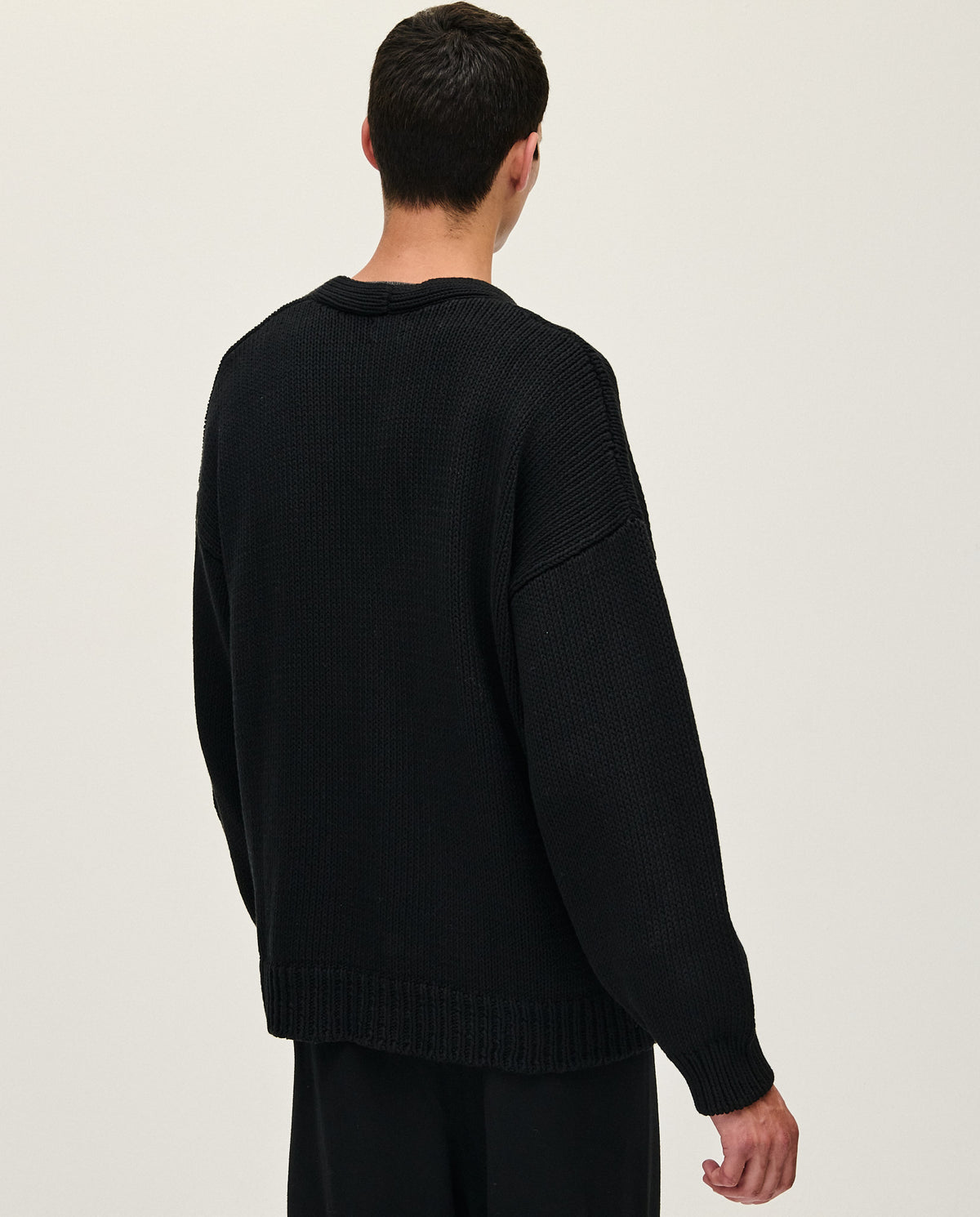 Black Babaà men's No16 cardigan featuring a cozy knit design, displayed on a neutral background with buttons and a relaxed fit.