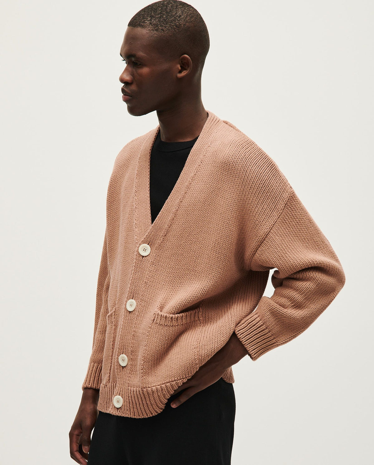 Babaà men's No16 roasted fig cardigan displayed on a hanger, showcasing the knit texture and earthy color.