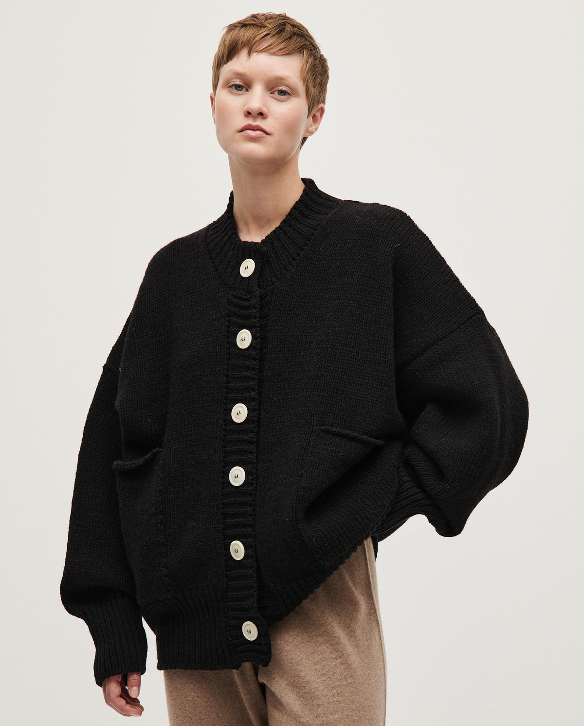 Black Babaà No11 women's cardigan displayed on a mannequin, featuring a cozy knit design and front button closure.