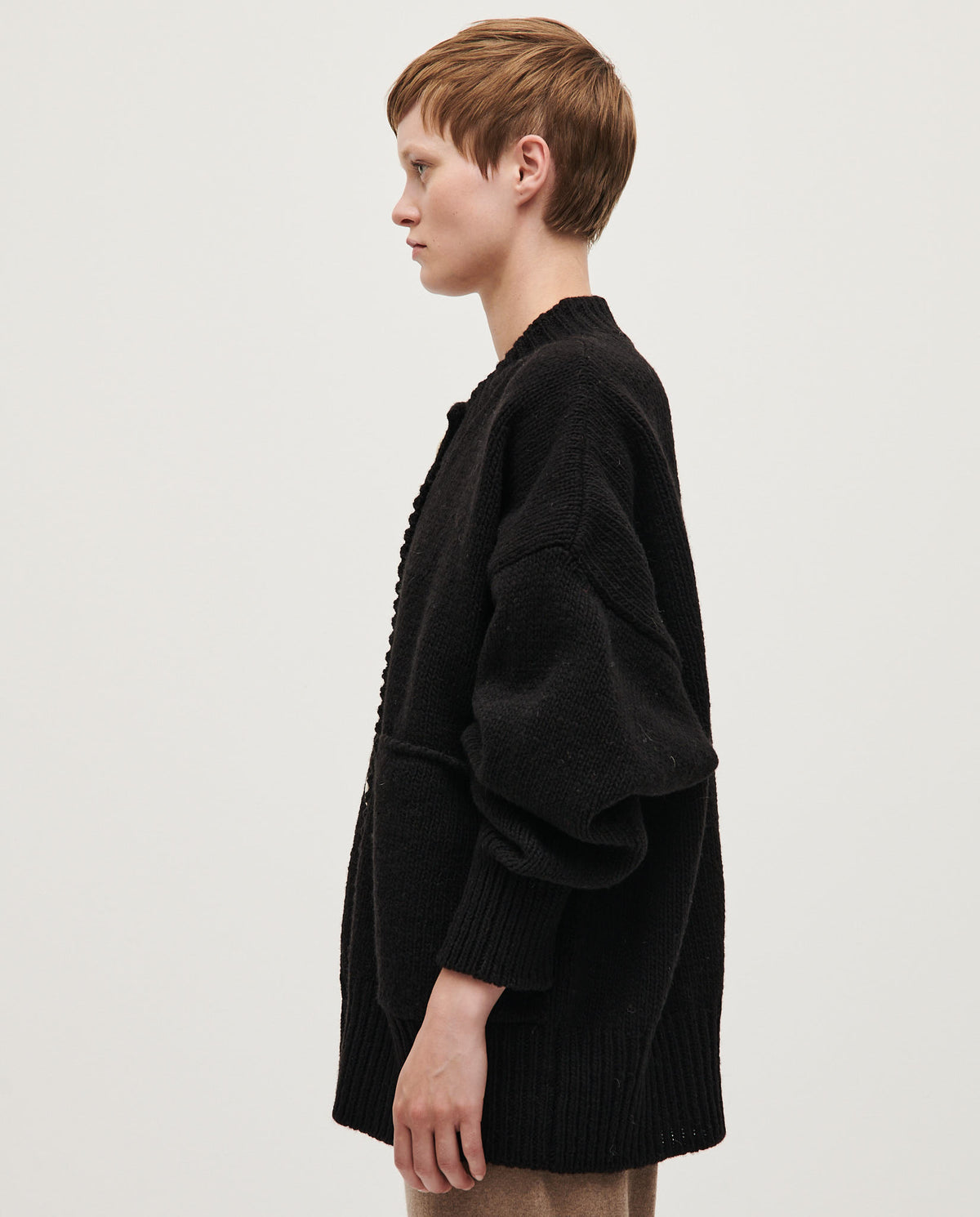 Black Babaà No11 women's cardigan displayed on a model, showcasing its soft knit fabric and relaxed fit.