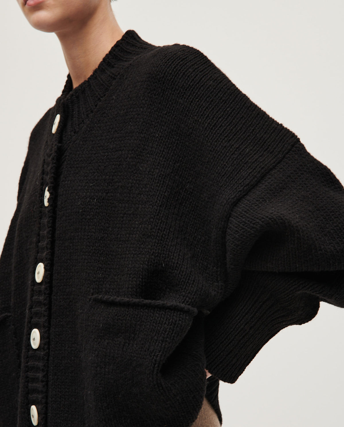 Black Babaà No11 women's cardigan displayed on a model, featuring a cozy knit design and button-front closure.