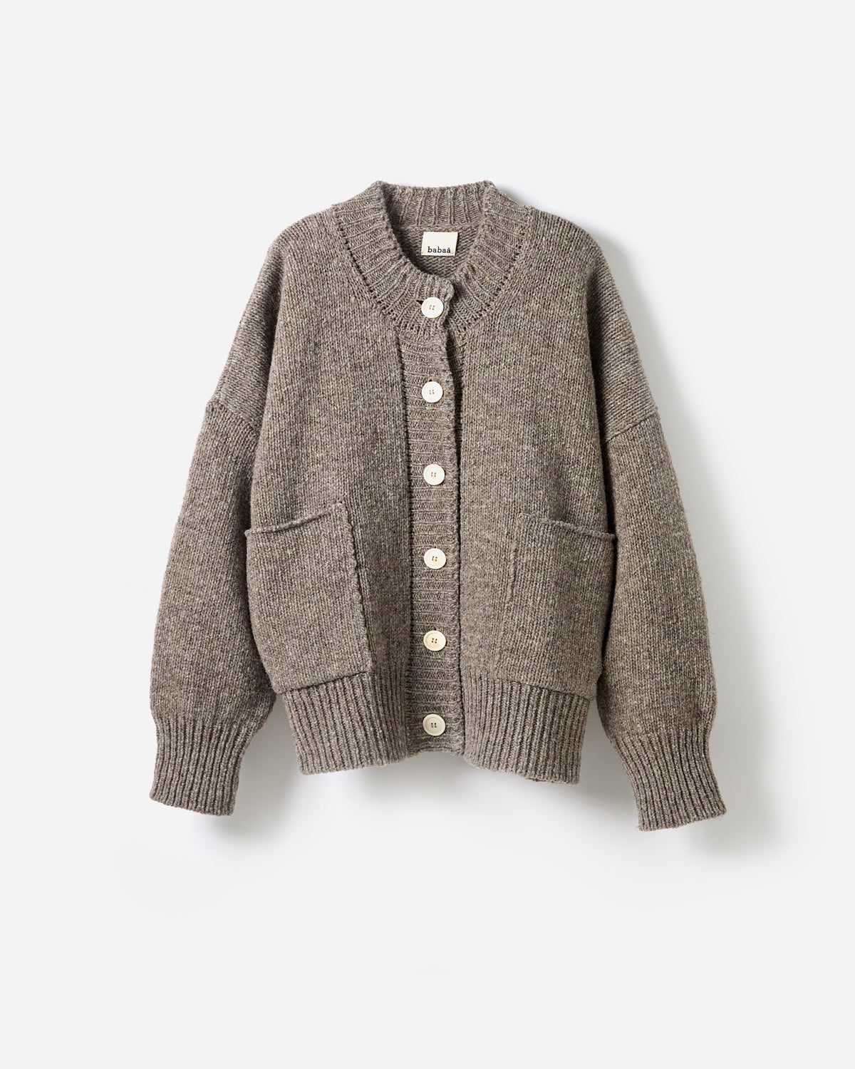 Silhouette of Babaà No11 dark mist cardigan worn by a woman, showcasing its relaxed fit and soft fabric in a natural setting.