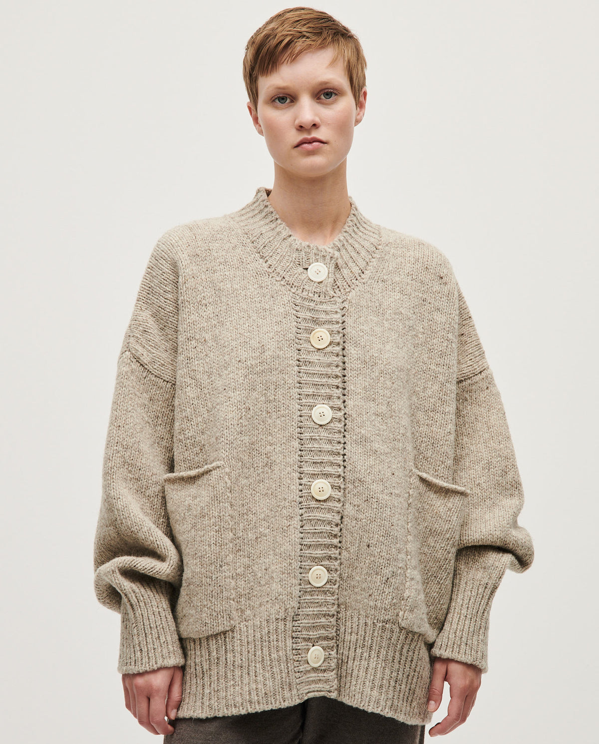 Light gray Babaà no11 Mist cardigan for women, featuring a soft knit texture and a relaxed fit, displayed on a hanger.