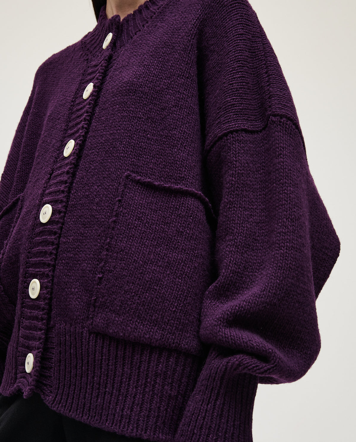 Purple Babaà No11 women's cardigan displayed on a hanger, showcasing its soft knit fabric and relaxed fit.