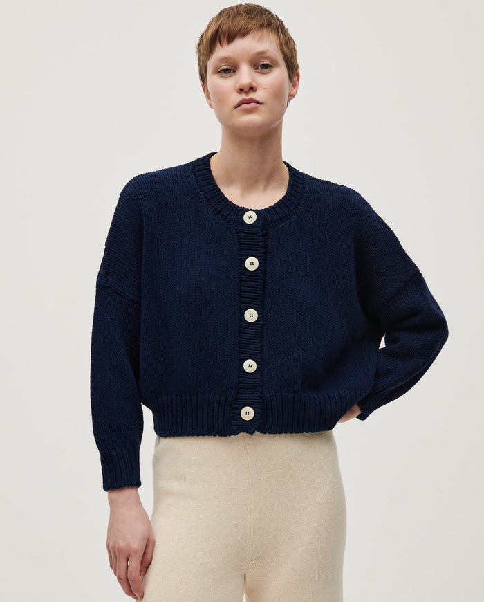 Navy women's cardigan No14 by Babaà, featuring a soft knit fabric and classic design, displayed on a hanger.