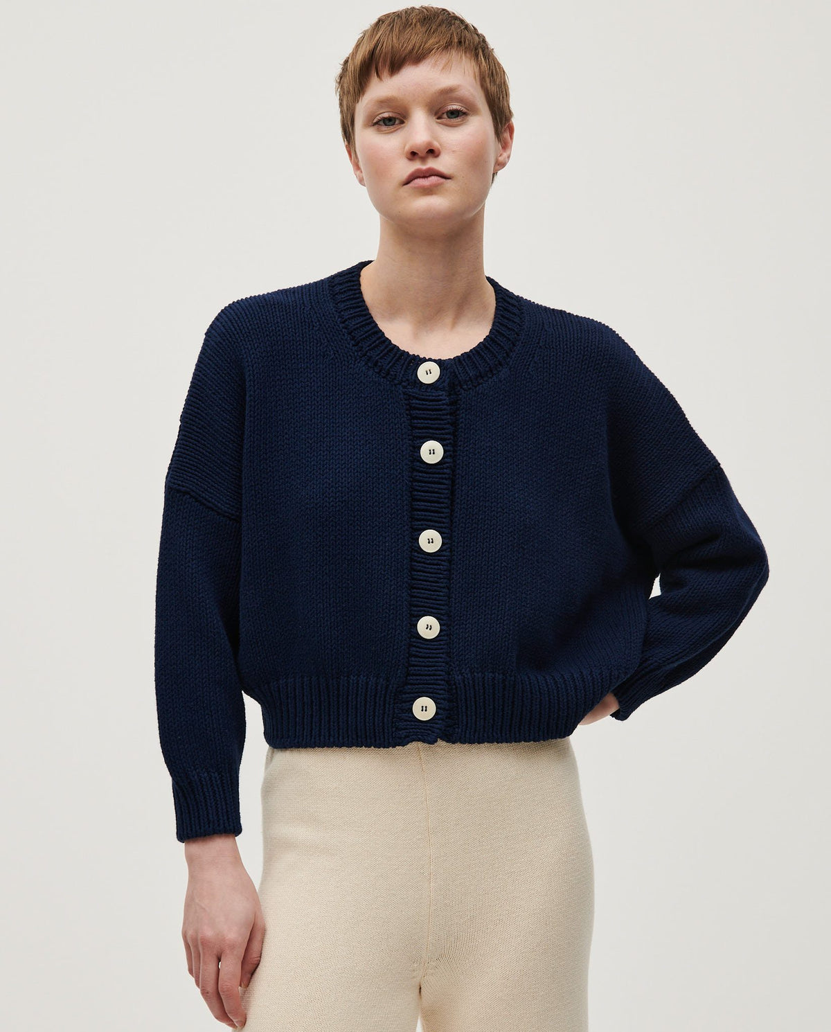 Navy women's cardigan No14 by Babaà, featuring a soft knit fabric and classic design, displayed on a hanger.
