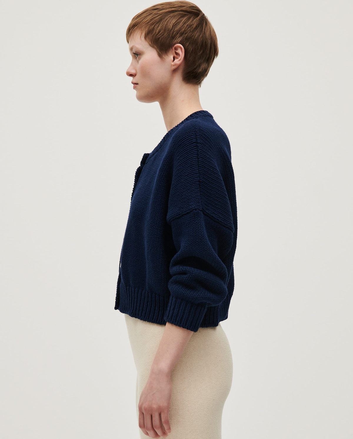 Navy women's Babaà Cardigan No14 featuring a cozy knit design and button closure, displayed on a hanger.