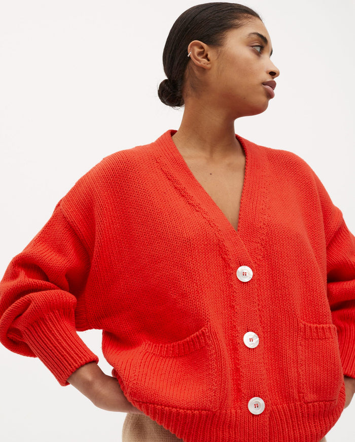 Babaà no16 summer flame women's cardigan in vibrant orange with a lightweight knit, shown on a model.