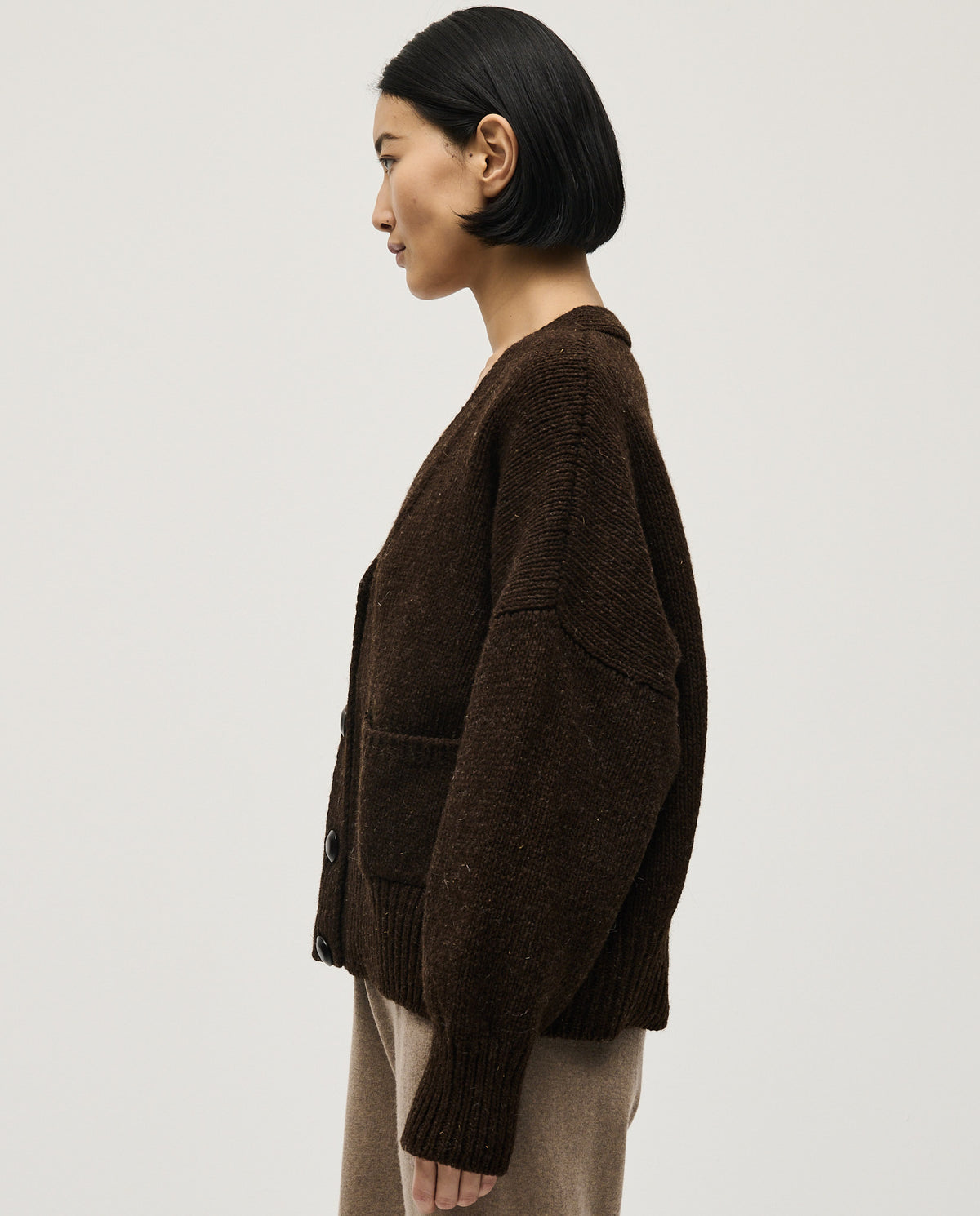 Babaà No17 Earth women's cardigan in soft knit, featuring a relaxed fit and earthy tone, displayed on a hanger against a neutral background.