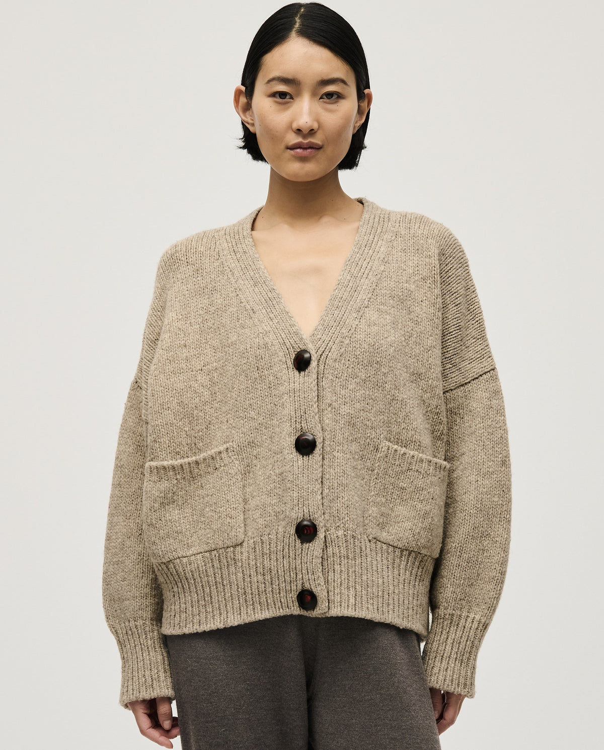 Light gray Babaà No17 Mist cardigan worn by a woman, featuring a soft knit fabric and relaxed fit.