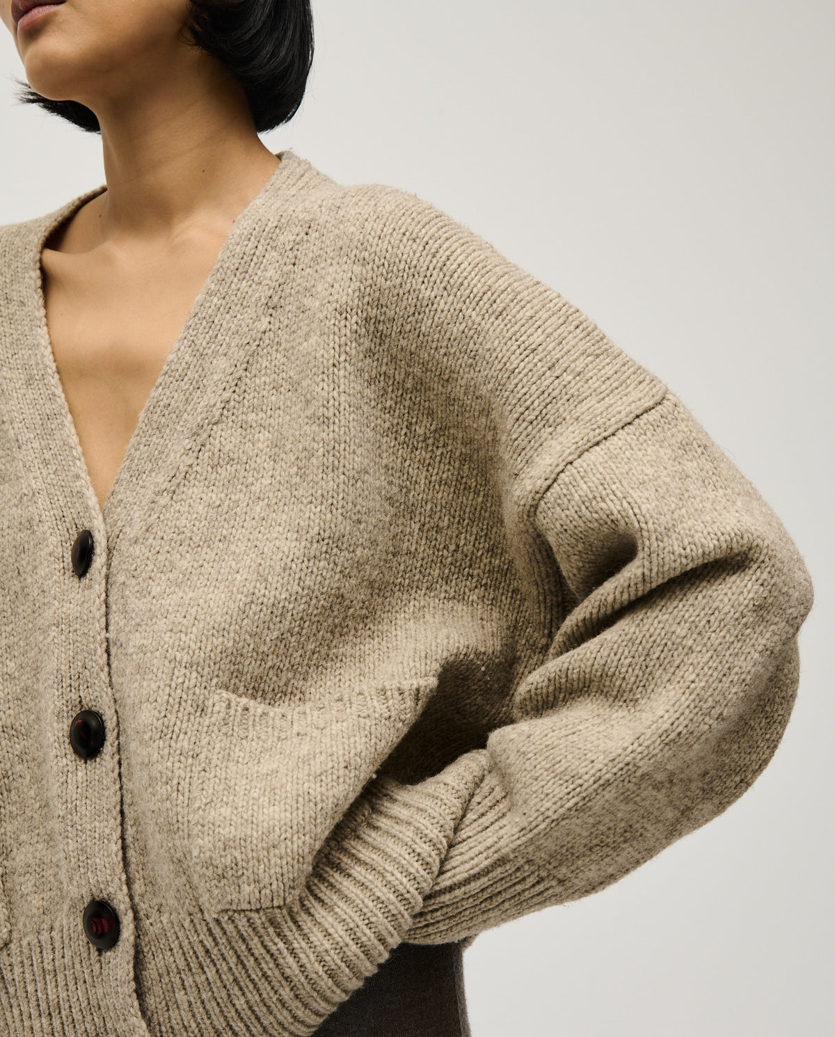Light gray Babaà No17 Mist women's cardigan featuring a soft knit fabric and relaxed fit, displayed on a hanger.