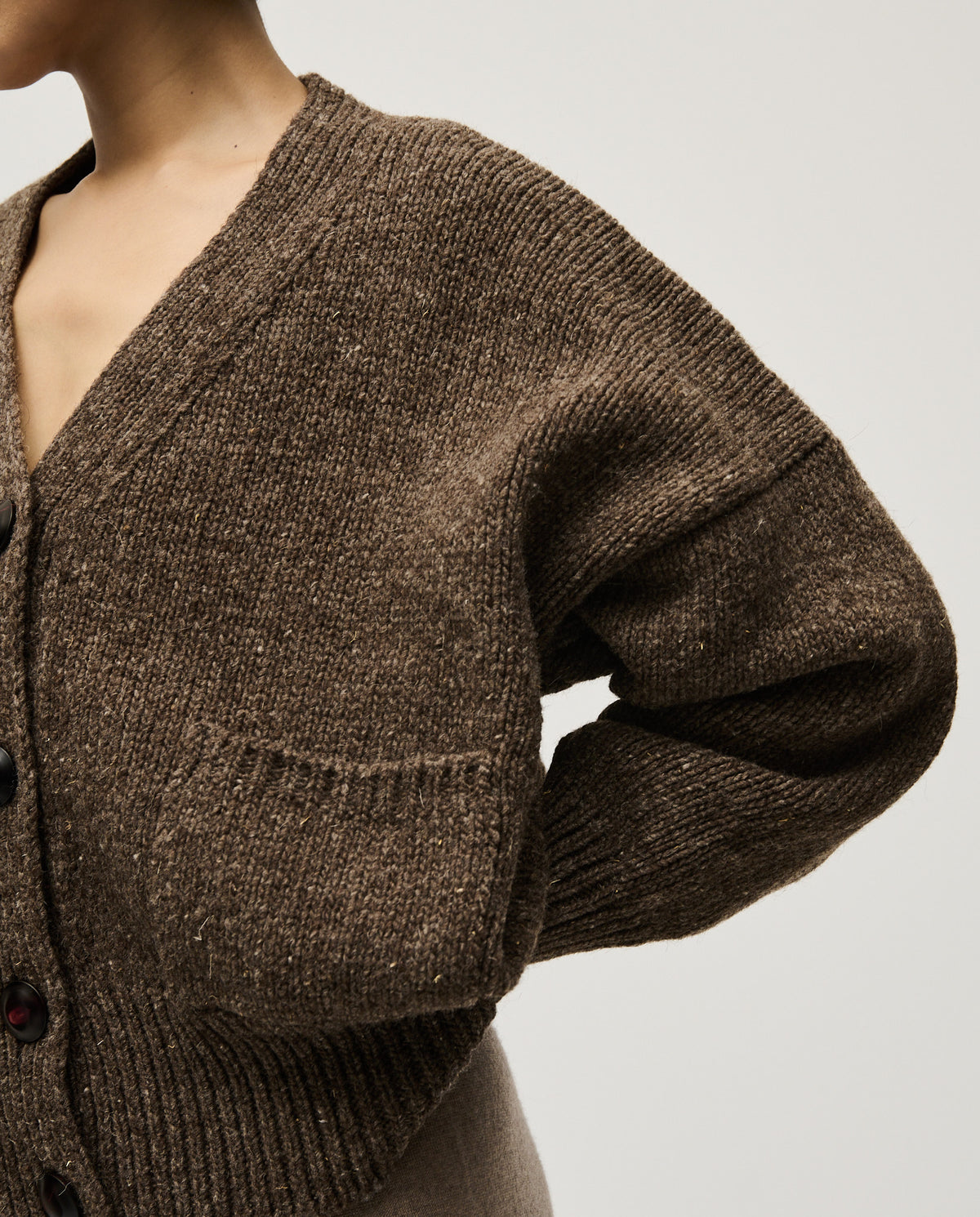 Woman wearing Babaà No17 Oak cardigan, featuring a cozy knit design in a warm oak color, styled with casual elegance.