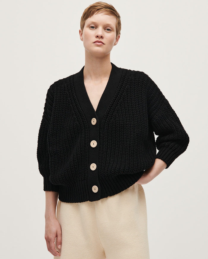Black Babaà No18 women's cardigan displayed on a mannequin, showcasing its soft knit fabric and stylish fit.