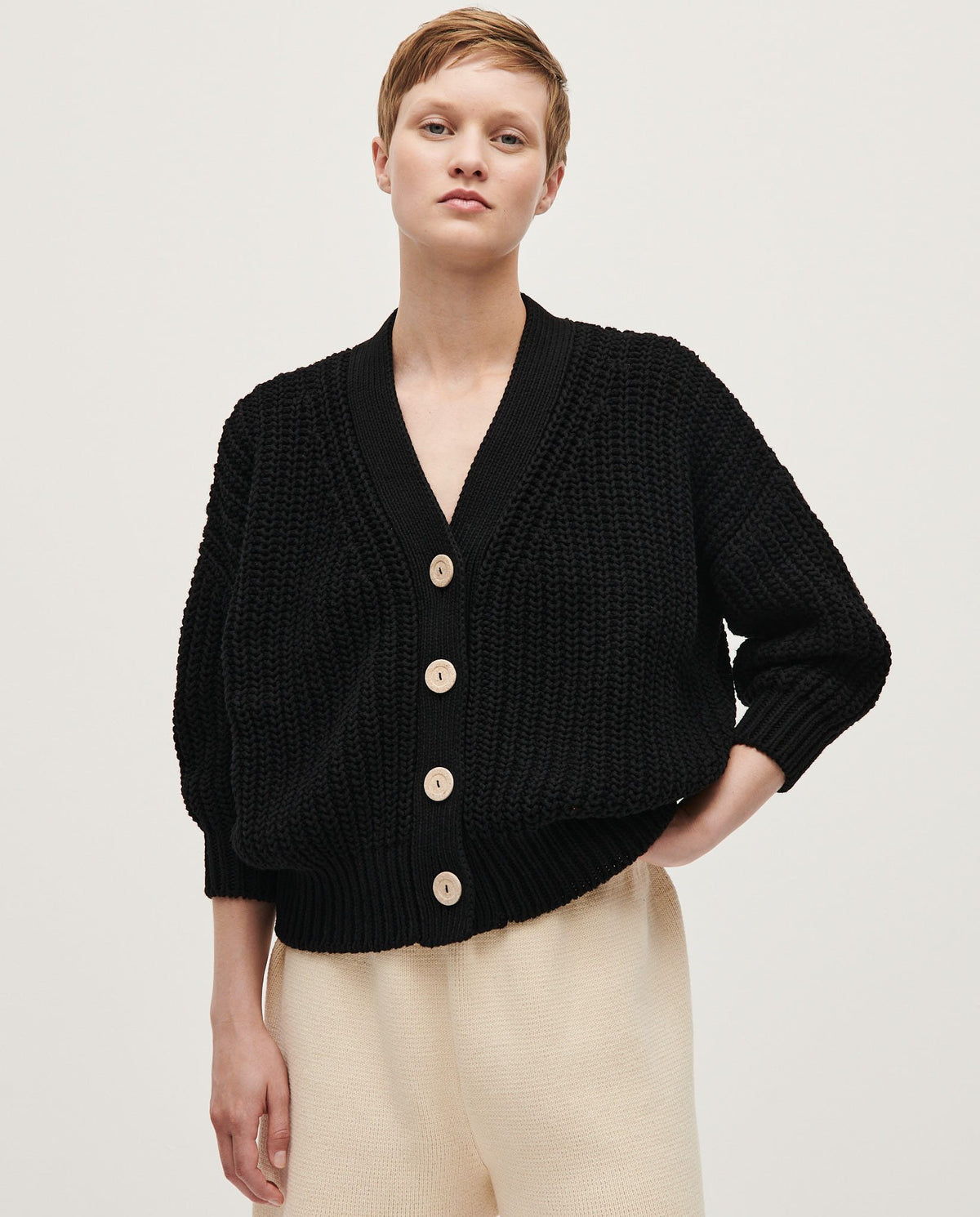 Black Babaà No18 women's cardigan displayed on a mannequin, showcasing its soft knit fabric and stylish fit.