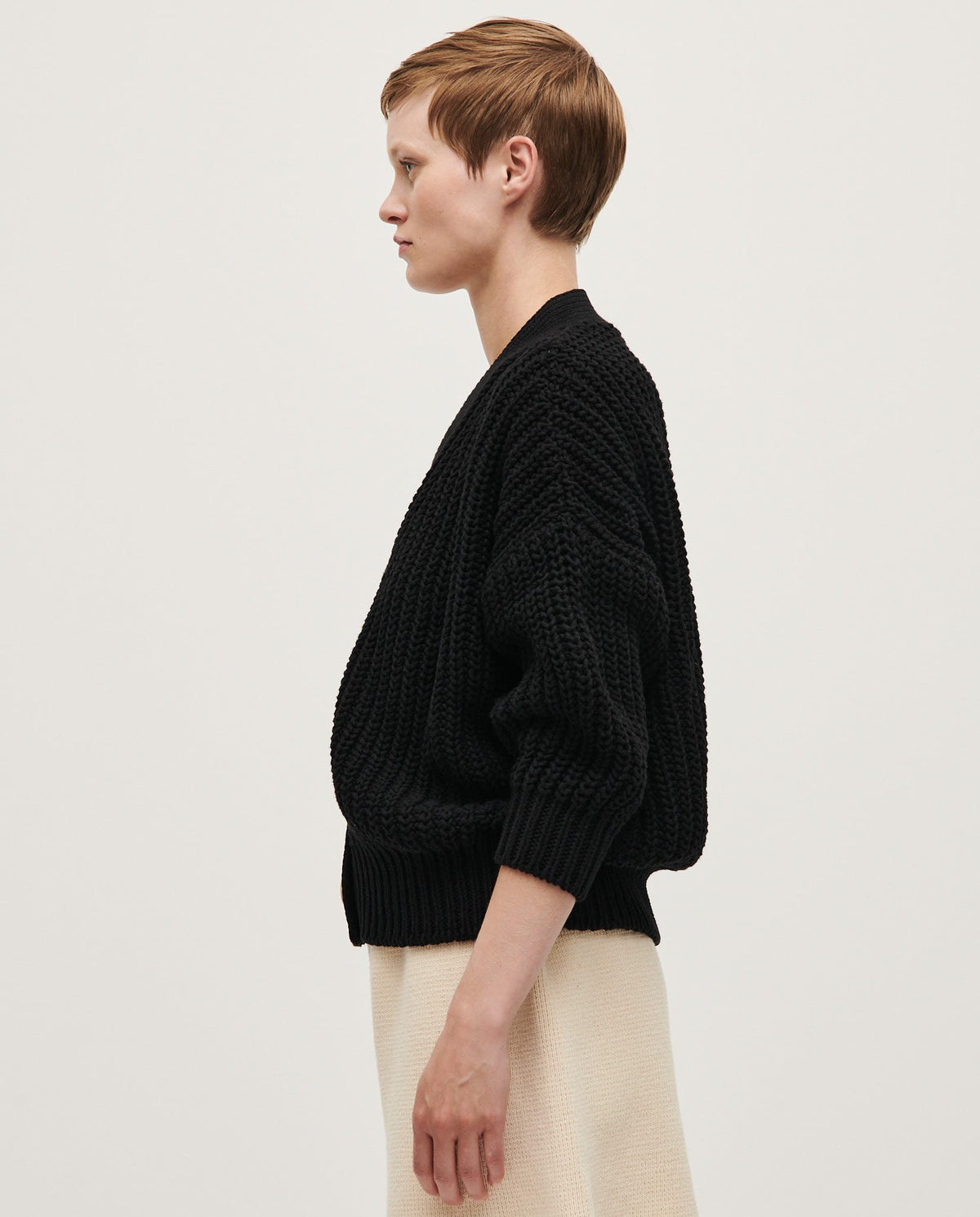 Black Babaà no18 women's cardigan displayed on a model, featuring a cozy knit design and button details.