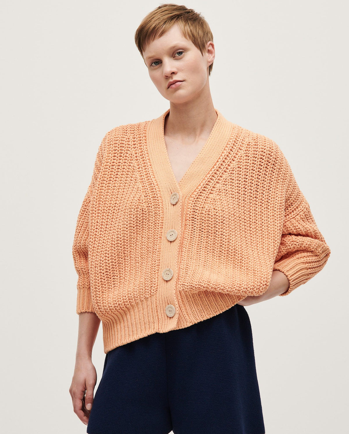 Babaà No18 Cantaloupe women's cardigan featuring soft knit fabric and a relaxed fit, displayed on a model.