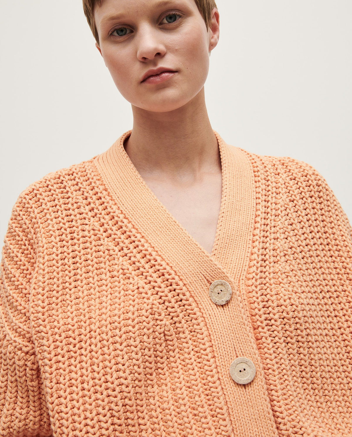 Babaà No18 Cantaloupe women's cardigan in soft knit fabric, featuring a relaxed fit and button-front design.