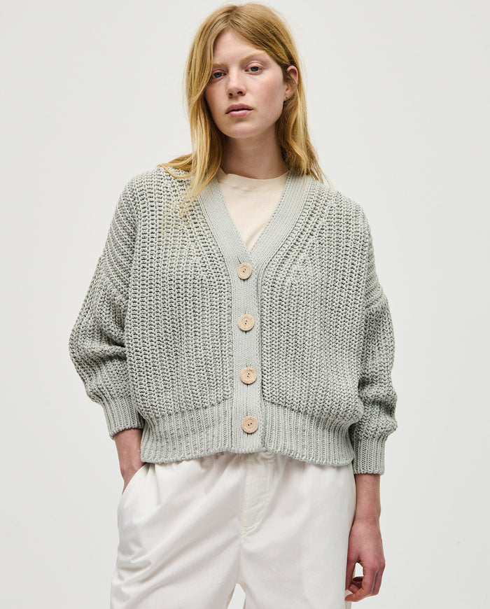Babaà No18 Chalk women's cardigan featuring soft knit fabric and a relaxed fit, displayed on a hanger against a neutral background.