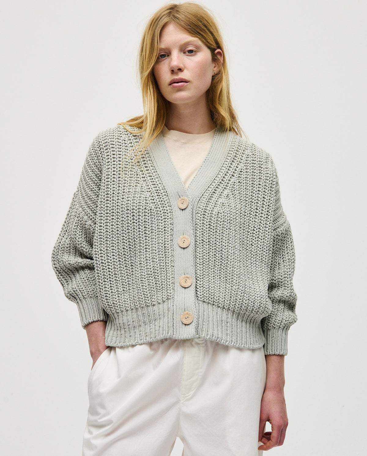 Babaà No18 Chalk women's cardigan featuring soft knit fabric and a relaxed fit, displayed on a hanger against a neutral background.