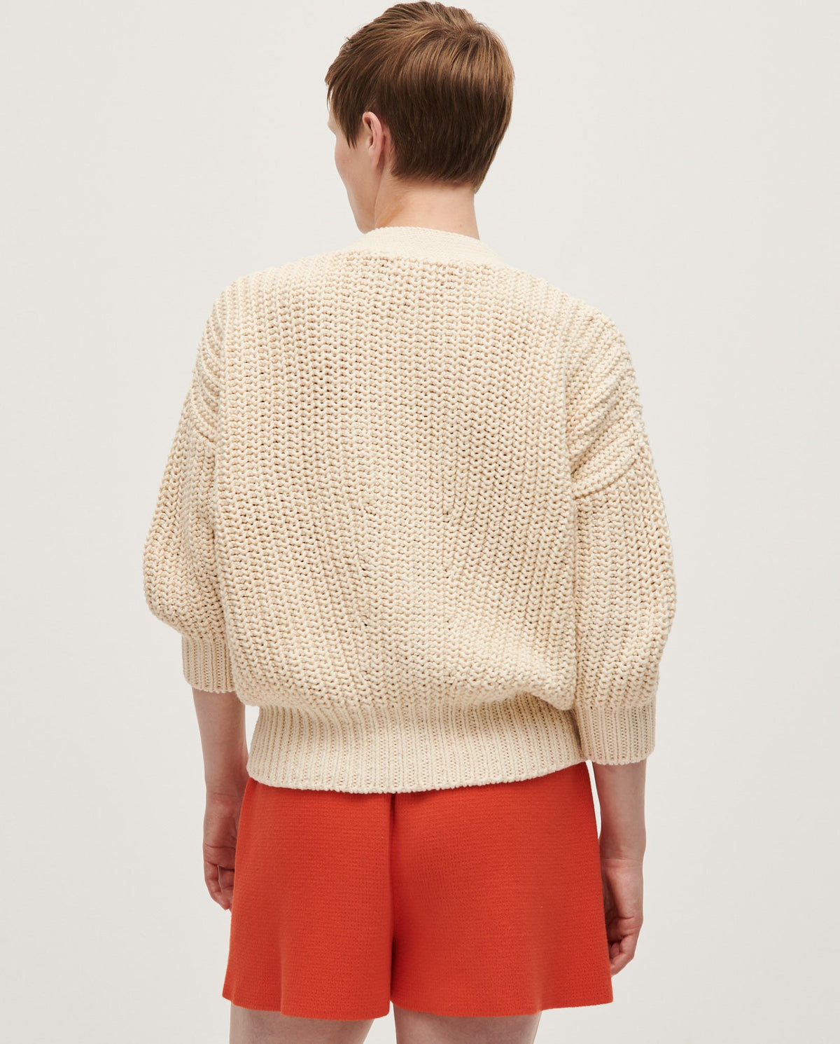 Babaà No18 natural women's cardigan, soft knit fabric with long sleeves and open front, displayed on a hanger.