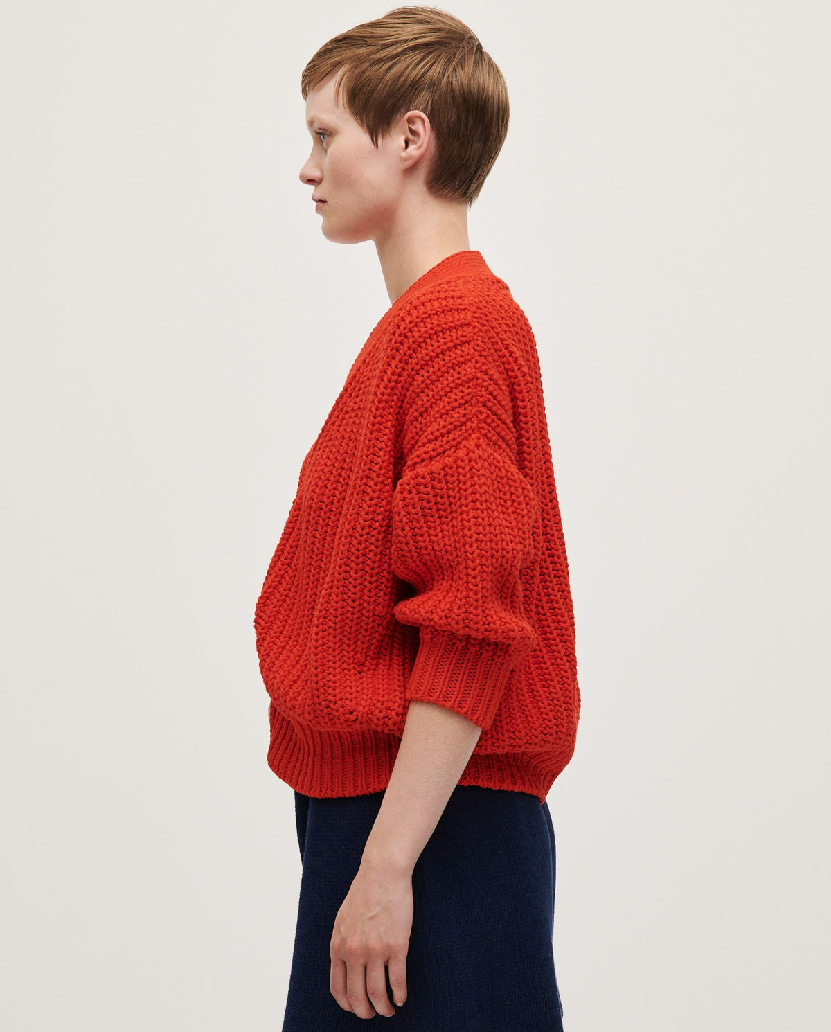 Babaà No18 Summer Flame women's cardigan, lightweight knit with warm flame-colored pattern, worn open over casual outfit.