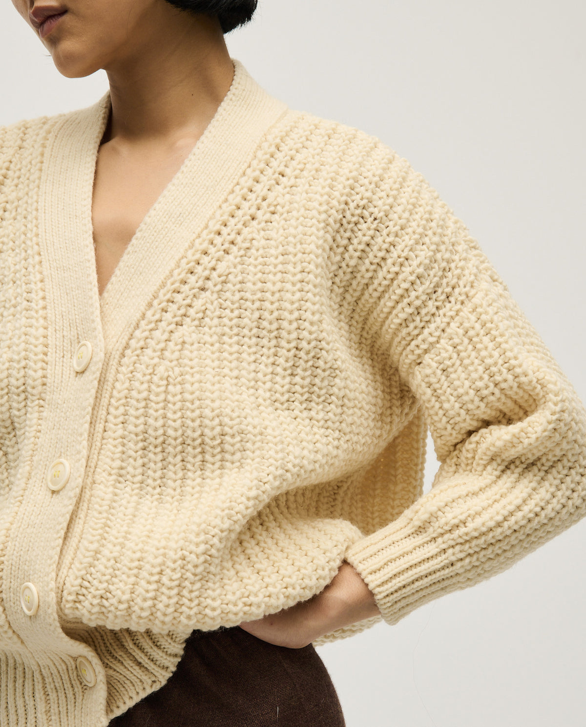 Babaà No19 natural women's cardigan displayed flat, showcasing its soft knit fabric and classic open-front design.