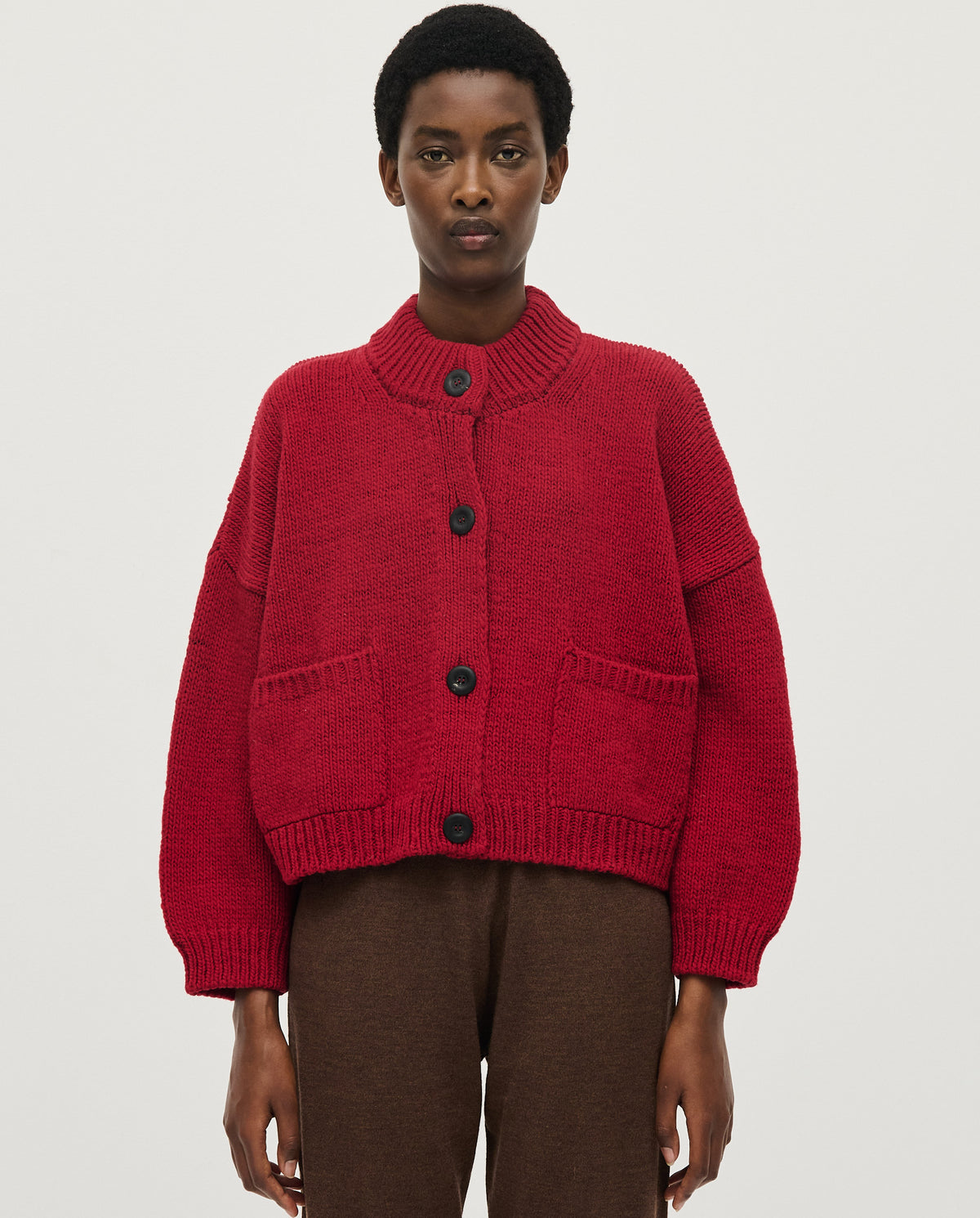 Babaà No23 Cereza women's cardigan in vibrant red, soft knit with button closure, styled with sleeves and collar detail.