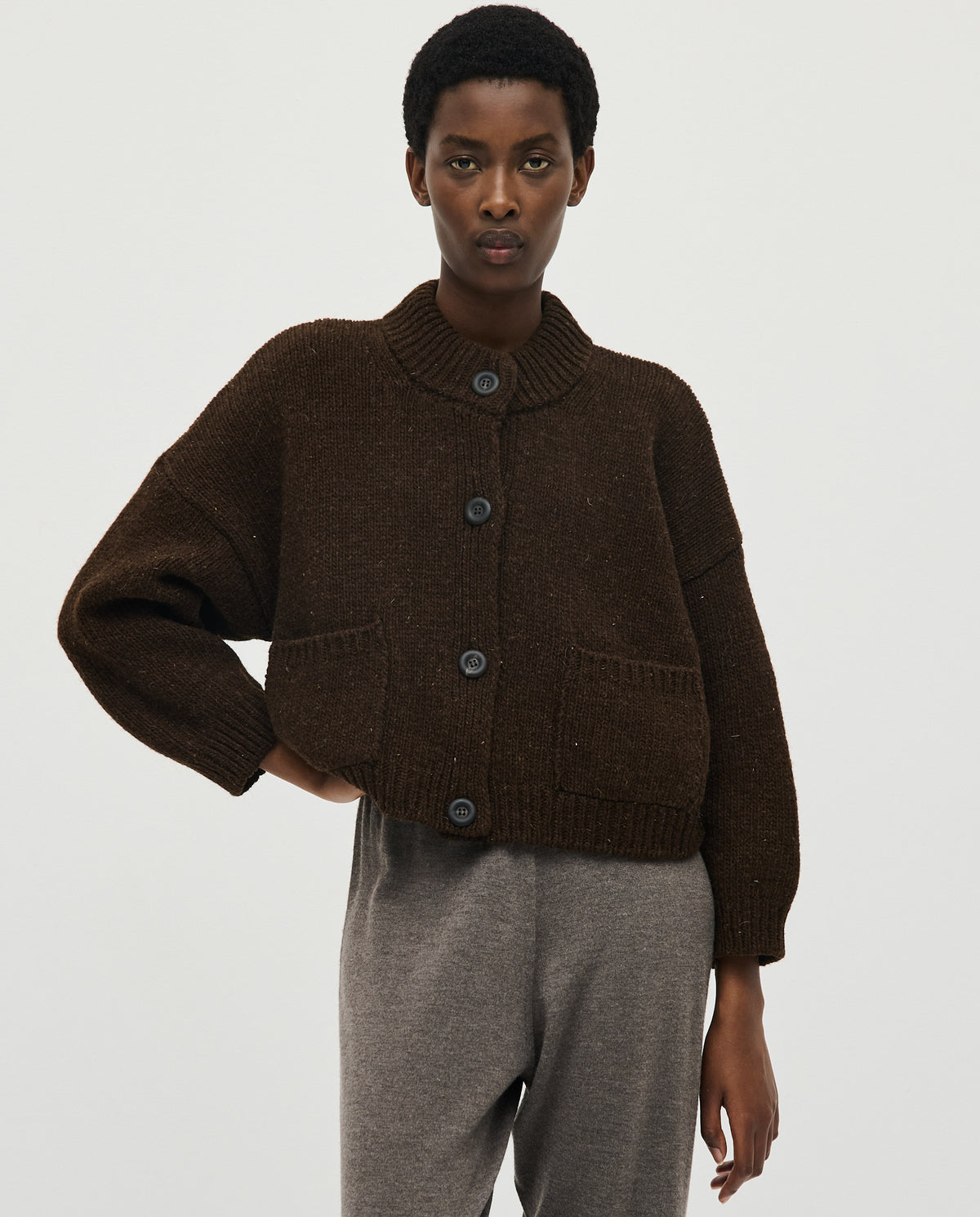 Babaà No23 Earth women's cardigan in neutral tone, soft knit fabric, button front, and relaxed fit, styled on a model.