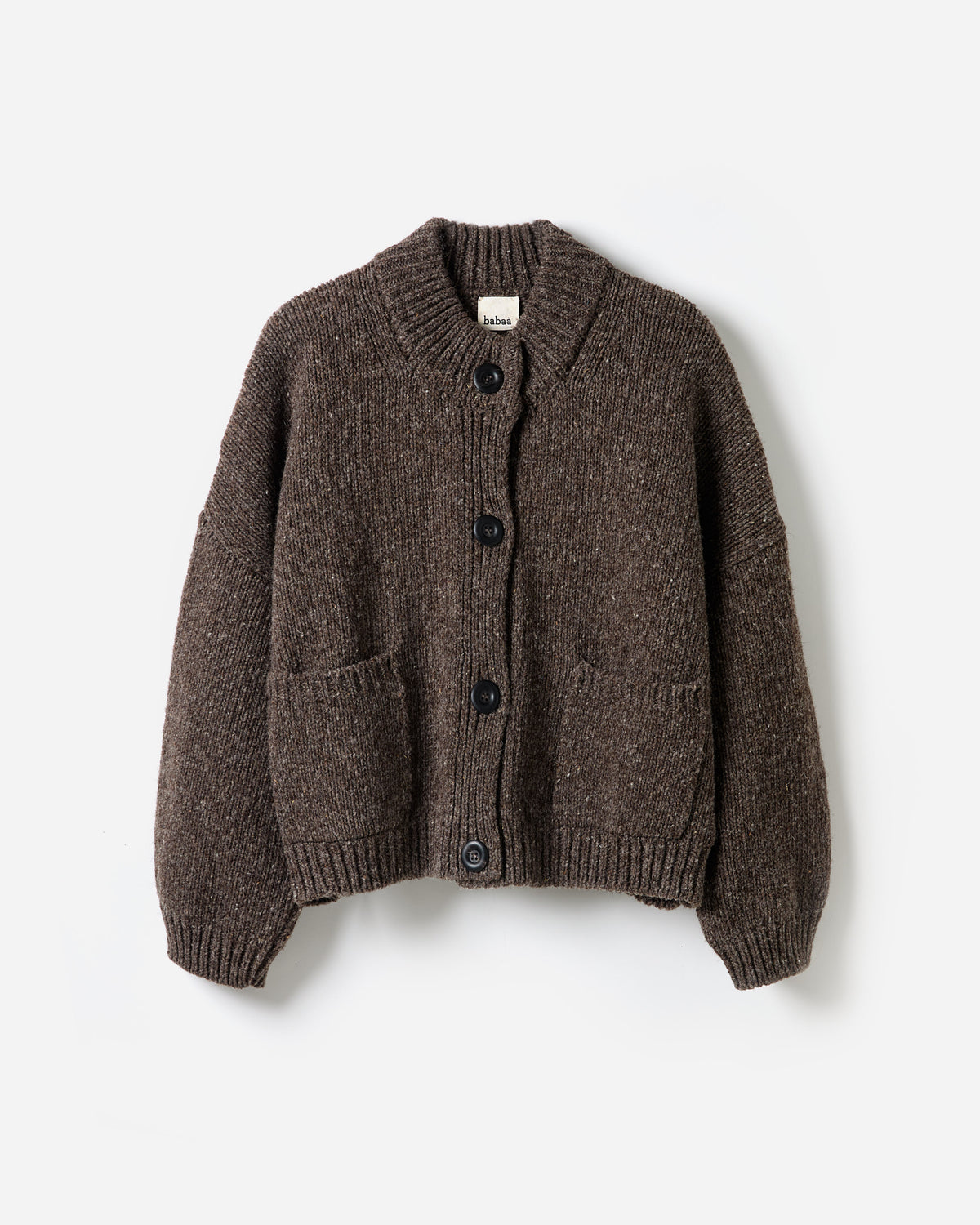 Woman wearing Babaà No23 Oak cardigan, showcasing its relaxed fit and soft knit texture in a stylish silhouette.
