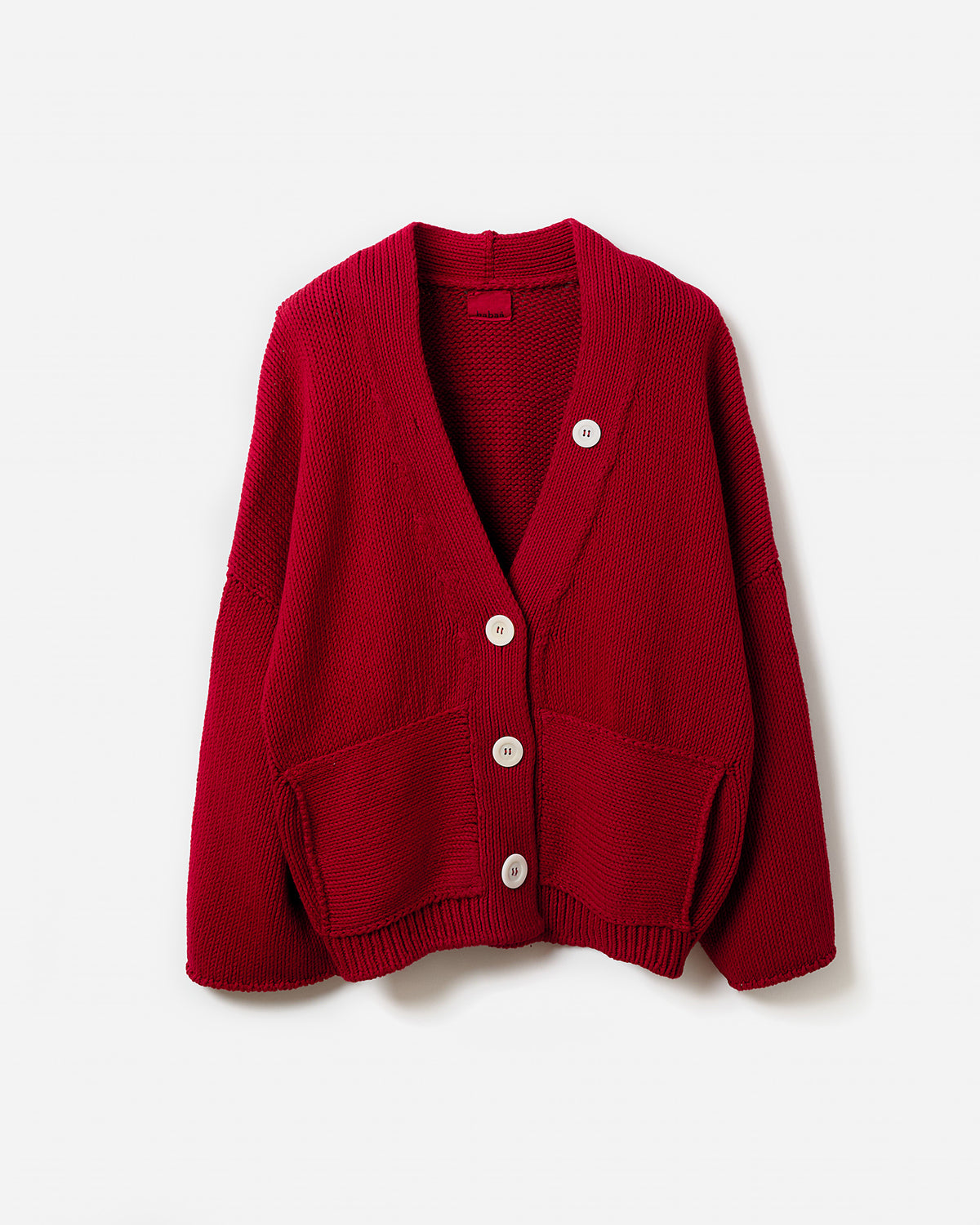 Babaà No26 Persephone women's cardigan in persimmon, silhouette view showing soft knit fabric and relaxed fit.