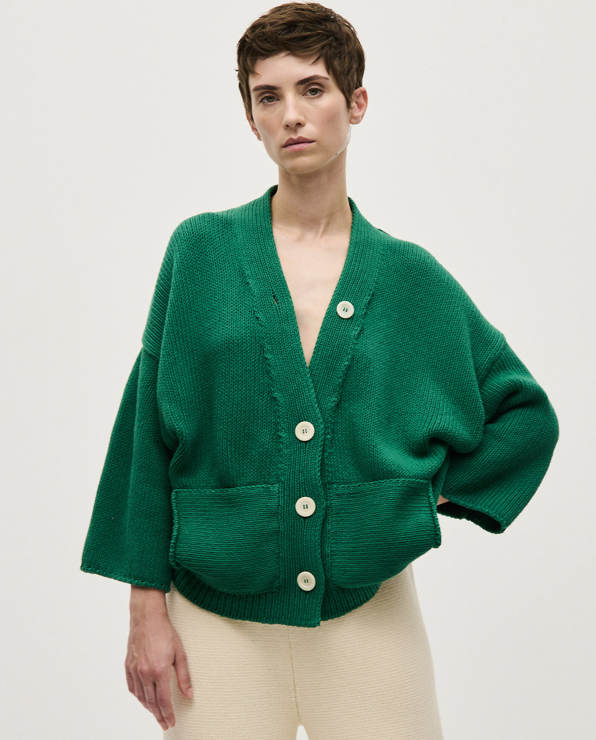 Woman wearing Babaà No26 Tree Fern cardigan featuring a cozy knit with green and beige tree fern pattern.