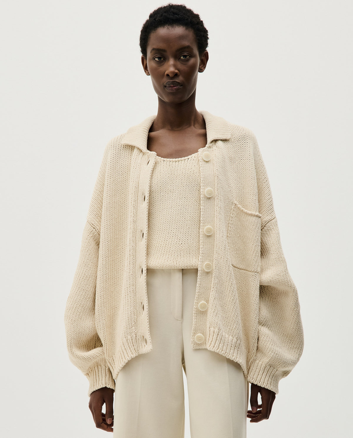 Woman wearing Babaà no44 natural cardigan, soft knit with a relaxed fit, styled for casual and cozy outfits.
