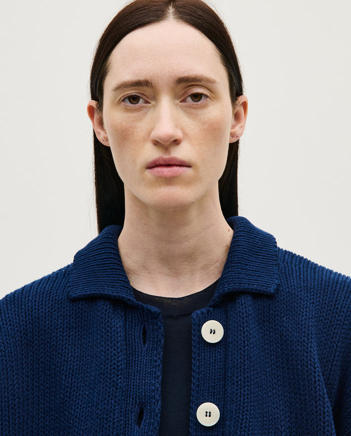 Navy babaà No44 women's cardigan with button-up front, soft knit fabric, and relaxed fit, displayed on a hanger.