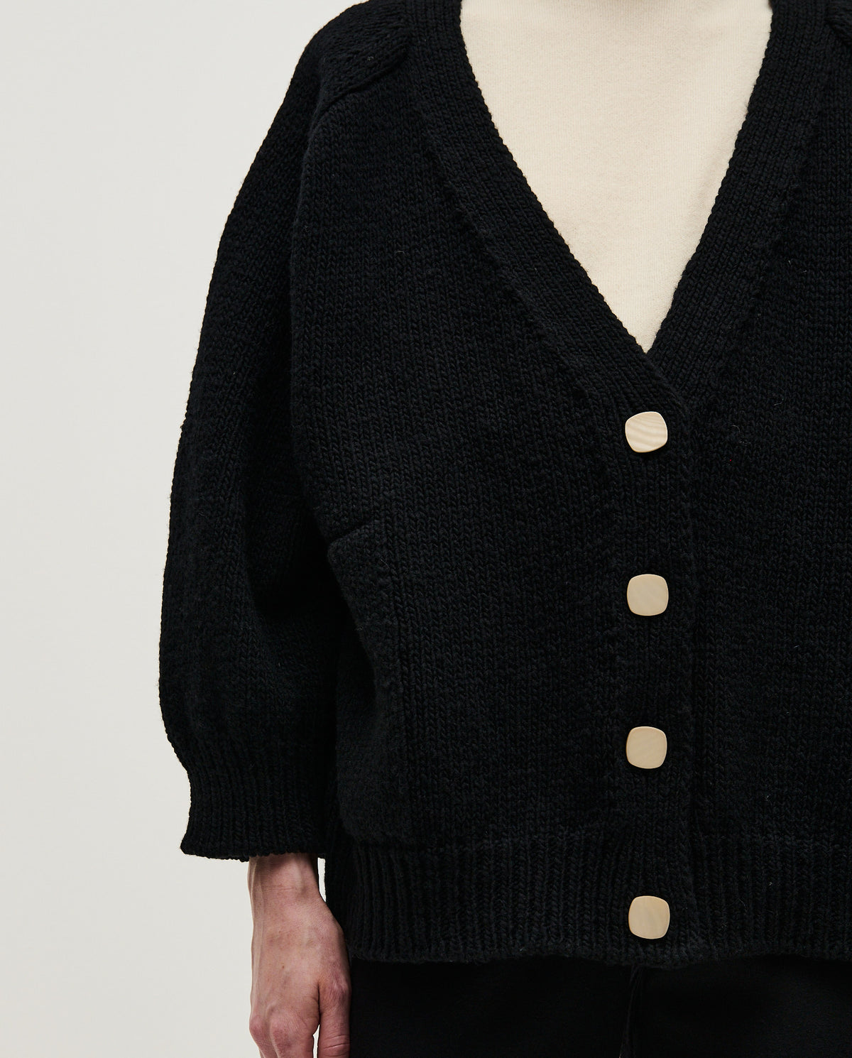Black Babaà No51 women's cardigan displayed on a model, showcasing a cozy, stylish knit sweater with a relaxed fit.