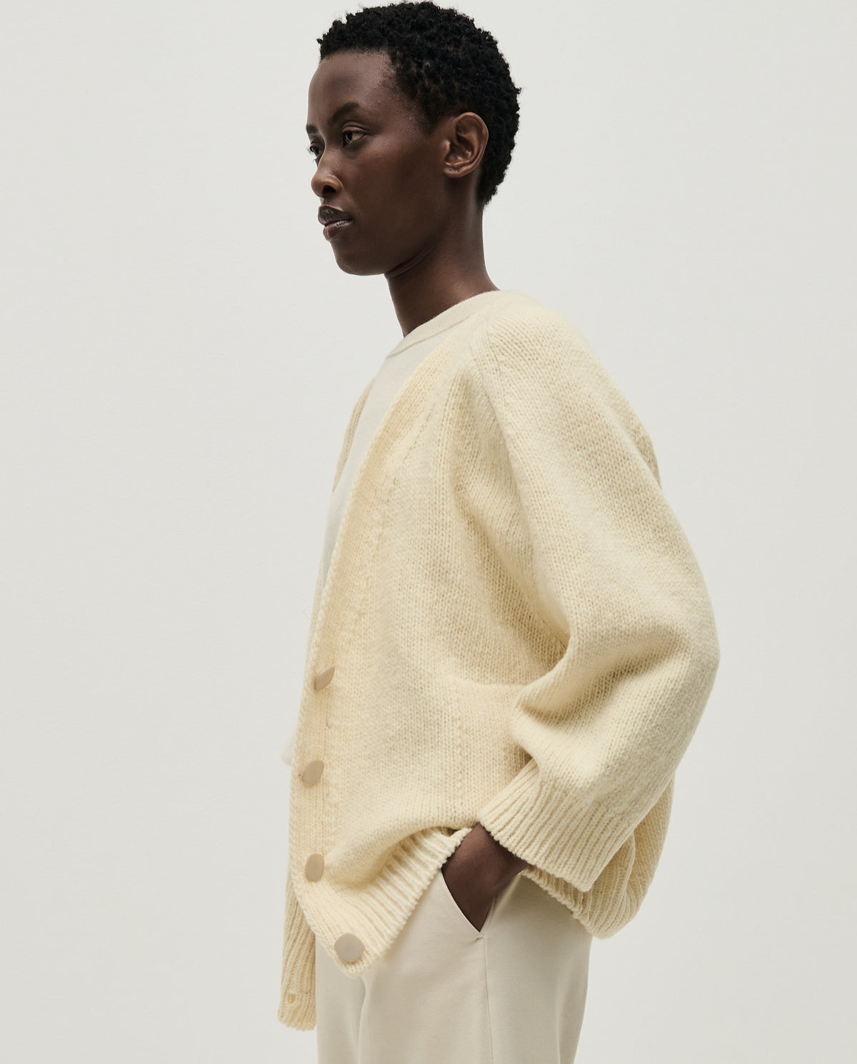 Light beige Babaà No51 women's cardigan displayed on a hanger, showcasing soft knit fabric and classic design.